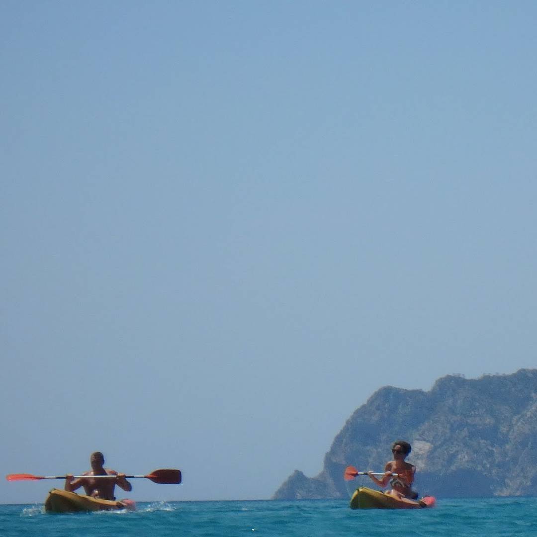 If you want a challenge try taking a picture of people canoeing while swimming. PeÃ±on de ifach in the background.
