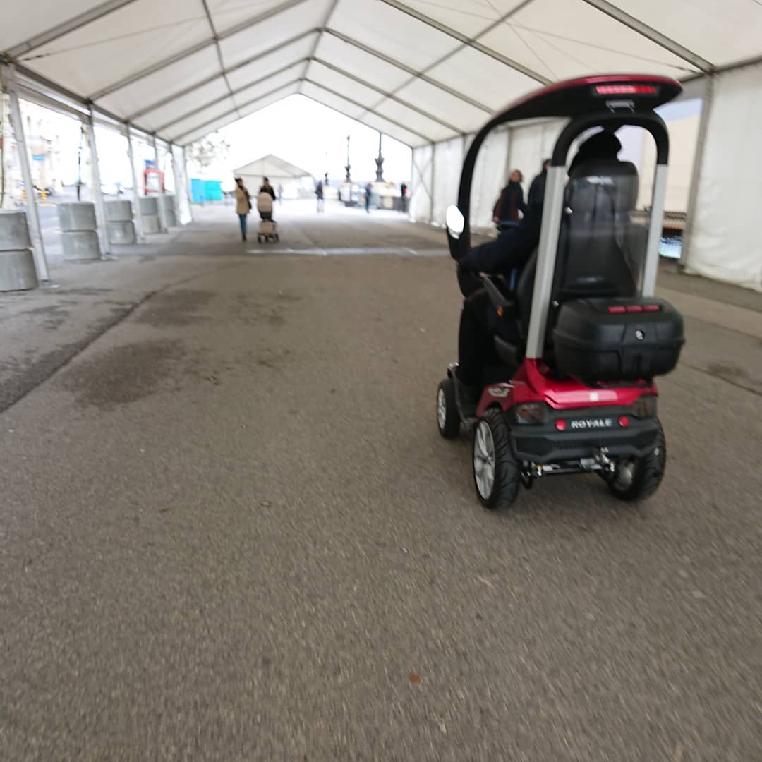 Behind the royal carriage.