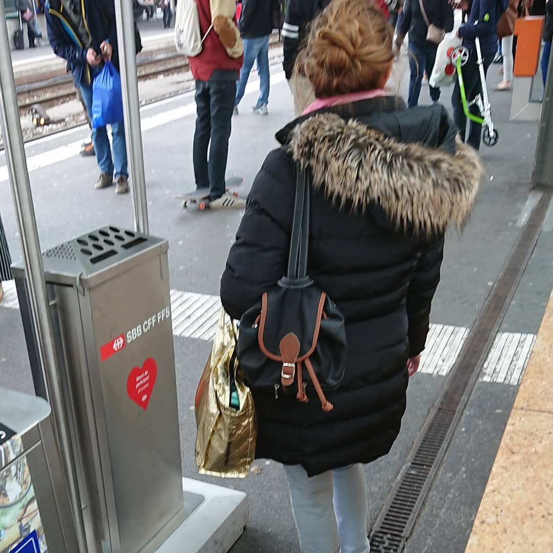 Cigarette smoking in the old fashioned train station of Geneva.